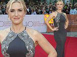 Actress Kate Winslet poses for photographs as she arrives on the red carpet at the gala for the film "The Dressmaker," at the 2015 Toronto International Film Festival in Toronto on Monday, Sept. 14, 2015. (Frank Gunn/The Canadian Press via AP)