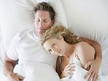 A stock photo of a man and a woman snuggling in bed asleep. 


AA68NN 
Image shot 2007. Exact date unknown.