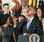 WASHINGTON, DC - SEPTEMBER 15: U.S. President Barack Obama tosses up a basketball given to him by coach Geno Auriemma (L) while honoring the 2015 NCAA Women's Basketball Champion University of Connecticut Huskies during a ceremony in the East Room at White House September 15, 2015 in Washington, DC. President Obama honored the Huskies for winning their third consecutive title with 10 overall.  (Photo by Mark Wilson/Getty Images)