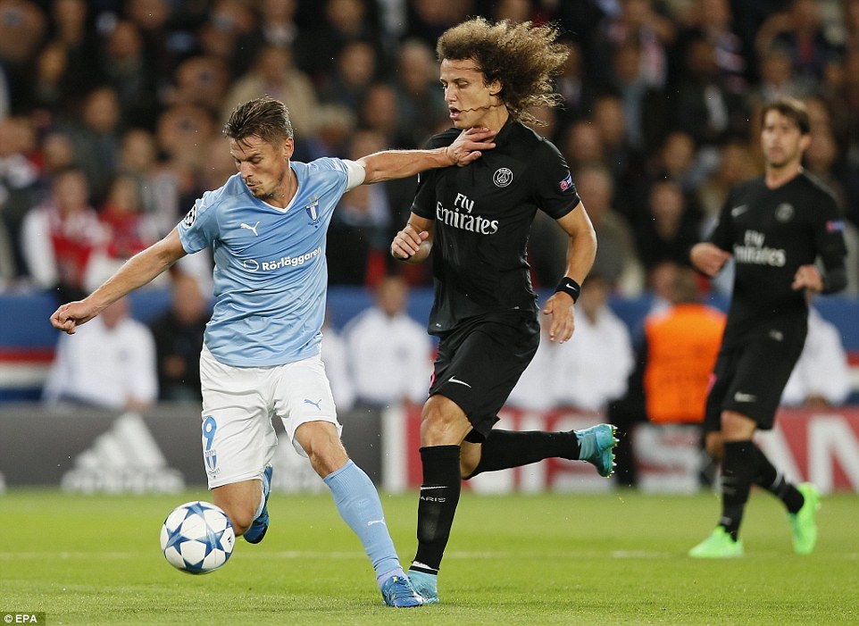 Former Chelsea defender David Luiz challenges Malmo's Markus Rosenberg (left) and receives a whack in the face