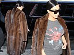 Kim Kardashian rocking a long fur coat and short leather skirt in NYC. The reality queen is also sporting shades and a Pink Floyd shirt. September 15, 2015 X17online.com