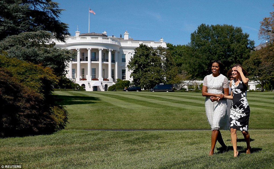 Mrs Obama, pictured on the White House lawn with Queen Letizia, opted to wear a summery windowpane check dress