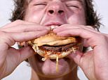 A man eating a burger.




A0G0DK Man eating fast food