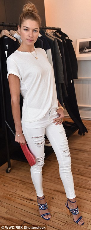 The girlfriend of billionaire Stavros Niarchos III, accessorised a loose white tee and ripped white jeans with embroidered, heeled sandals, and a red, studded clutch