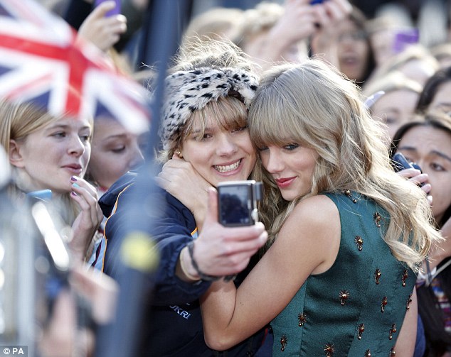 Affectionate: Swift hugs a fan as she arrives for the BBC Radio 1 Teen Awards in London in 2013