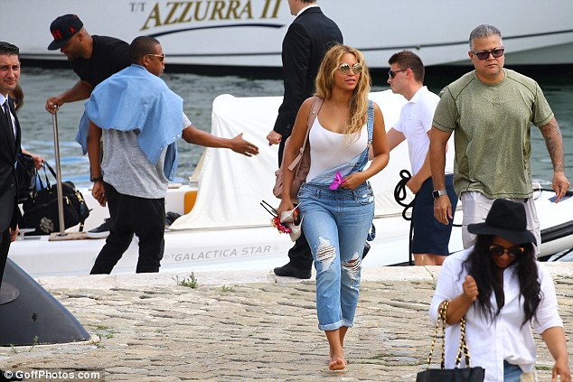 Her gang: As well as her security team, the popular was accompanied by her husband Jay-Z and their three-year-old daughter Blue Ivy