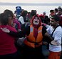 A woman reacts as she arrives aboard a dinghy after crossing from Turkey, to the island of Lesbos, Greece, on Saturday, Sept. 19, 2015. A girl about five years old died and at least 13 undocumented refugees and migrants were missing on Saturday after a boat transferring dozens of people from Turkey to Greece overturned off Lesbos island, Greek Coast Guard said. (AP Photo/Petros Giannakouris)