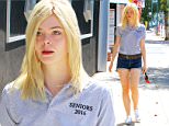 September 18, 2015: Elle Fanning spotted with a 'Seniors 2016' shirt and denim shorts on her way to a studio today in Los Angeles, CA.\nMandatory Credit: Lek/INFphoto.com Ref: infusla-294