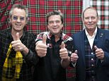 The Bay City Rollers today announced their reunion at Glasgow Central Hotel. 22 September 2015.
l-r Guitarist Stuart John ëWoodyí Wood, singer Les McKeon and bassist Alan Longmuir.
The Bay City Rollers were a Scottish pop band whose popularity was highest in the mid 1970s. The British Hit Singles & Albums noted that they were "tartan teen sensations from Edinburgh", and were "the first of many acts heralded as the 'Biggest Group since The Beatles' and one of the most screamed-at teeny-bopper acts of the 1970s". For a relatively brief but fervent period (nicknamed "Rollermania"), they were worldwide teen idols. The group's line-up featured numerous changes over the years, but the classic line-up during its heyday included guitarists Eric Faulkner and Stuart John Wood, singer Les McKeown, bassist Alan Longmuir, and drummer Derek Longmuir.
© Russell Gray Sneddon / StockPix.eu