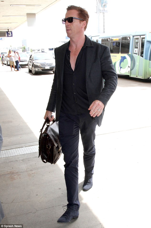 Jet-setting style: Damian Lewis cut a low-key figure in an all-black outfit as he flew out of LAX on Monday following the Emmys in which Homeland narrowly missed out on an award to Game of Thrones