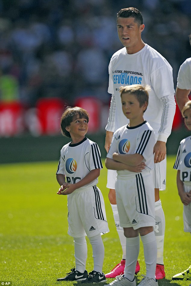 Looking up in awe at his hero Ronaldo, the young Syrian refugee posed for photographs with the Real Madrid stars who were wearing T-shirts in support of the thousands of desperate Syrian refugees