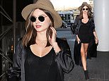 Please contact X17 before any use of these exclusive photos - x17@x17agency.com   Miranda Kerr flying solo with boots, tight dress and hat heading out of LAX  September 22, 2015 X17online.com