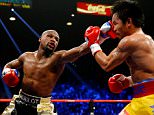 Floyd Mayweather Jr. throws a left at Manny Pacquiao during their welterweight unification championship bout on May 2, 2015 at MGM Grand Garden Arena in Las Vegas, Nevada.  

LAS VEGAS, NV - MAY 02:  
(Photo by Al Bello/Getty Images)
