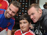 MANCHESTER, ENGLAND - SEPTEMBER 21:  Juan Mata and Wayne Rooney of Manchester United pose with Baris, 13, from Wigan, at the MU Foundation Dream Day, where poorly children meet the Manchester United team, at Aon Training Complex on September 21, 2015 in Manchester, England.  (Photo by Ian Cartwright/Man Utd via Getty Images)