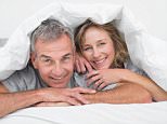 DW0FPY Cheerful middle aged couple under the duvet. Image shot 10/2013. Exact date unknown.