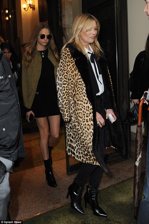 Wild side! Later in the day, Kate and Cara left the building and the older of the two covered up in her trademark leopard print coat