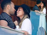 UK CLIENTS MUST CREDIT: AKM-GSI ONLY\nEXCLUSIVE: Rio de Janeiro, Brazil - John Legend and Chrissy Teigen display their Love while enjoying the view from their hotel balcony in Rio, Legend is currently in Town to perform during Rock in Rio music festival. Chrissy Teigen  took a few pictures and wore a maxi white cardigan over her blouse and Daisy Dukes showing off her long legs.\n\nPictured: John Legend and Chrissy Teigen\nRef: SPL1134354  220915   EXCLUSIVE\nPicture by: AKM-GSI / Splash News\n\n