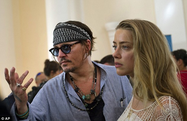 Johnny Depp and wife Amber Heard talk with the media in Rio de Janeiro before the concert on Thursday 