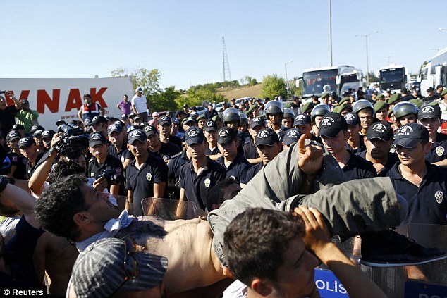 Tensions mounting: Migrants react as Turkish police and gendarmes block migrants on a highway near Edirne, Turkey