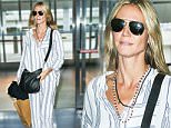 EXCLUSIVE TO INF.\nOctober 1, 2015: Heidi Klum is seen make-up free as she jets off from JFK airport in New York City. Mandatory Credit: PapJuice/INFphoto.com Ref: infusny-285