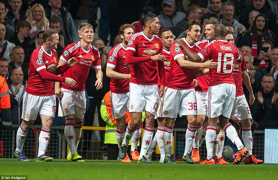 The Manchester United team celebrate together after Smalling had given his side the lead in their Champions League clash with Wolfsburg