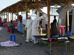 Nurses wearing personal protective equipment (PPE) treat ebola patients at the Kenama treatment center run by the Red Cross Society on November 15, 2014 ©Francisco Leong (AFP/File)