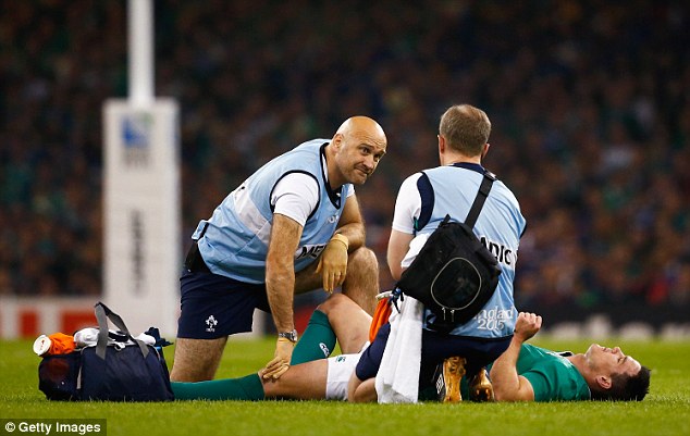 A look of worry is on the face of a Irish medic as Sexton lies flat on his back and awaits the prognosis
