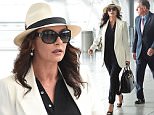 EXCLUSIVE: Catherine Zeta Jones with a feather in her hat arrives at JFK airport in NYC.\n\nPictured: Catherine Zeta Jones\nRef: SPL1151230  141015   EXCLUSIVE\nPicture by: Ron Asadorian / Splash News\n\nSplash News and Pictures\nLos Angeles: 310-821-2666\nNew York: 212-619-2666\nLondon: 870-934-2666\nphotodesk@splashnews.com\n