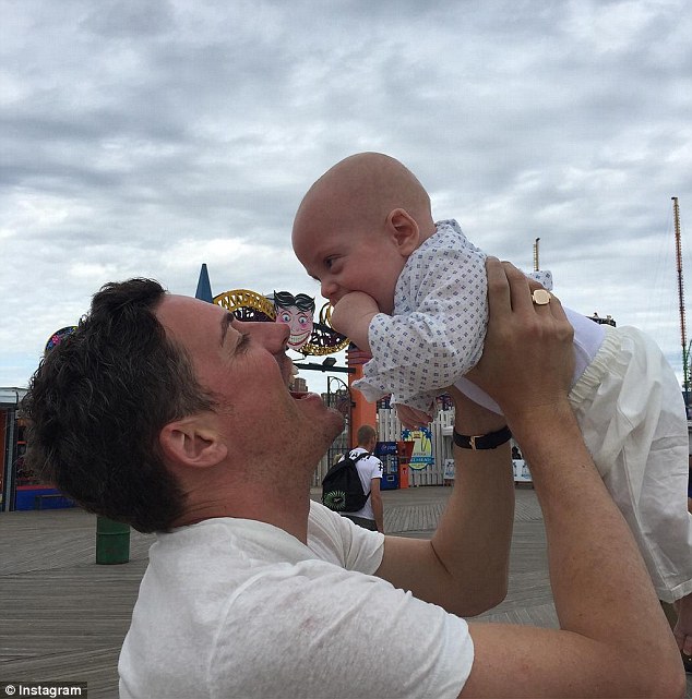 Doting dad: The Armageddon star revealed her engagement on social media; pictured here is her fiance, David, holding their son, photo from her Instagram