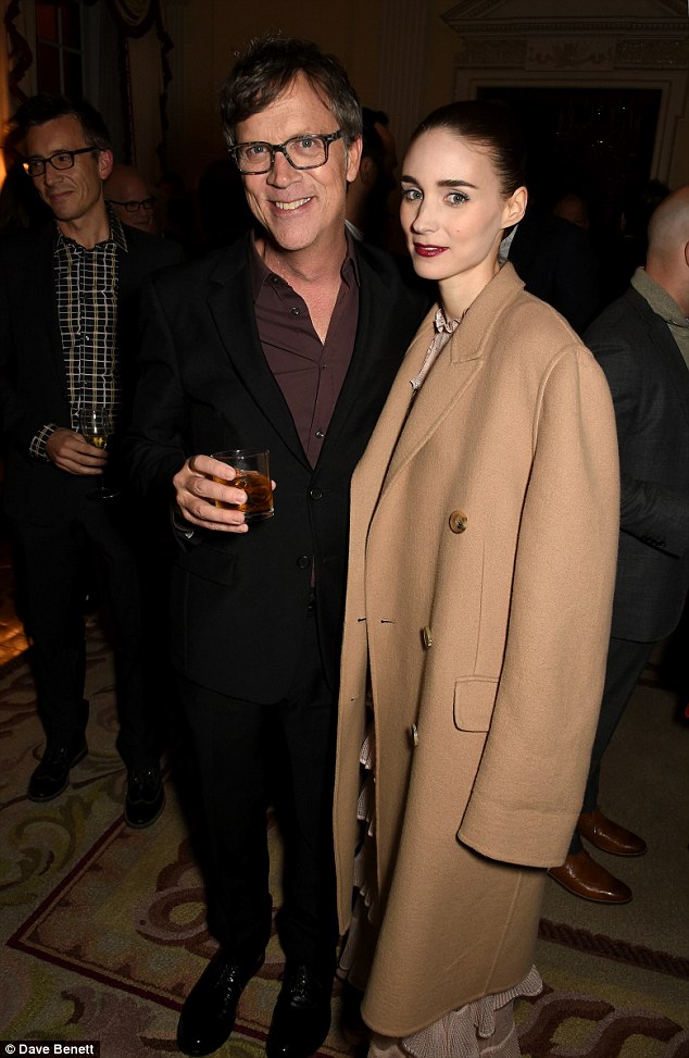 Caped and cosy: Rooney Mara kept her red carpet dress covered under her chic beige coat, as she spent time chatting to director Todd Haynes