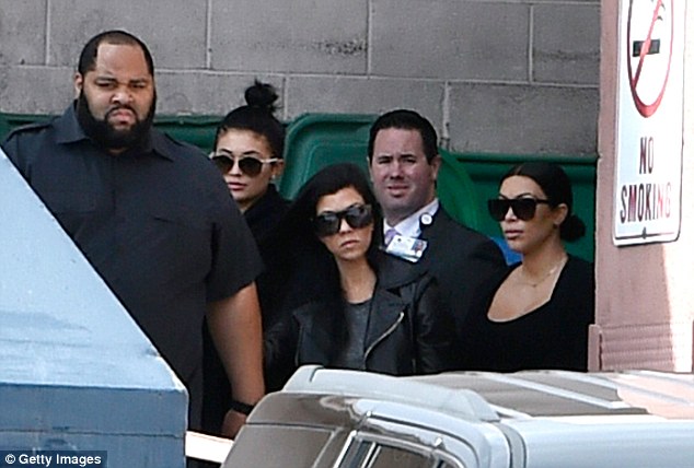 Kylie Jenner, (2nd L) Kourtney Kardashian (C) and Kim Kardashian (R) exit through a back door after visiting Lamar Odom on Thursday