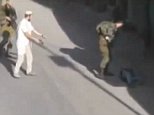 ATTENTION EDITORS - VISUAL COVERAGE OF SCENES OF INJURY OR DEATHA Jewish settler holding his pistol after he shot and killed a Palestinian man is seen in this still image taken from a video shot by Youth Against Settlements and obtained by Reuters TV, in the West Bank city of Hebron October 17, 2015. Three Palestinians were shot dead on Saturday in what Israel said were thwarted knife attacks, but a Palestinian witness of one incident said it was a result of Jewish settler violence, as tensions ran high after more than two weeks of unrest. The shooting occurred near a Jewish settlement in the West Bank city of Hebron. The Israeli military said a Palestinian attempted to stab an Israeli civilian, who was carrying a gun and then shot and killed the attacker. REUTERS/REUTERS TV/  ATTENTION EDITORS - THIS PICTURE WAS PROVIDED BY A THIRD PARTY. REUTERS IS UNABLE TO INDEPENDENTLY VERIFY THE AUTHENTICITY, CONTENT, LOCATION OR DATE OF THIS IMAGE. EDITORIAL USE ONLY. NOT FOR SALE FOR MARKETING
