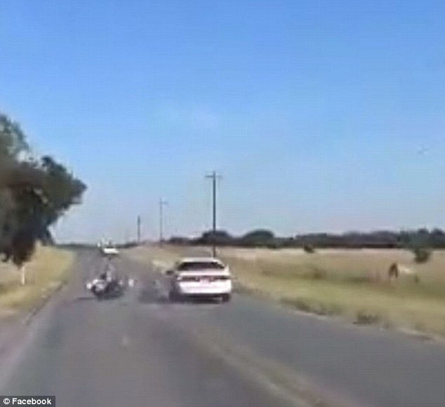 As Sanders approaches the second vehicle, the car suddenly swerves and clips the motorcycle. The impact sends Sanders and Simpson into a field next to the road as the bike flies in the opposite direction
