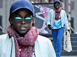 10/18/15 NYC - Lupita Nyong'o goes incognito in a blue cap and shades as she walks in soho with her printed bag, "Doing Things" and leather, letter jacket, "Ratta" wearing denim flare jeans in Soho on Sunday October 18th, 2015. Non-Exclusive / Luis Yllanes / Splash News\n\nPictured: Lupita Nyongo\nRef: SPL1154687  181015  \nPicture by: Luis Yllanes / Splash News\n\nSplash News and Pictures\nLos Angeles: 310-821-2666\nNew York: 212-619-2666\nLondon: 870-934-2666\nphotodesk@splashnews.com\n