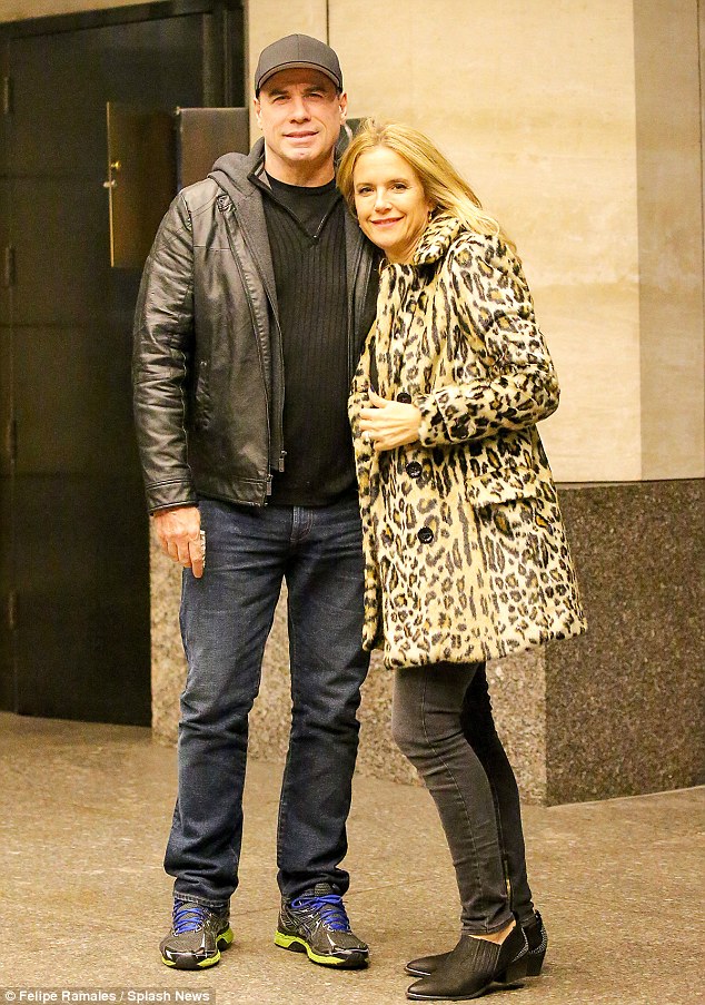 Bundled for autumn in New York! Longtime Hollywood couple John Travolta and Kelly Preston embraced outside their Manhattan hotel on Sunday evening