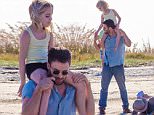 UK CLIENTS MUST CREDIT: AKM-GSI ONLY\nEXCLUSIVE: Tybee Island, GA - Chris Evans holds co-star Mckenna Grace on his shoulders as they film a scene for 'Gifted' in Tybee Island, Georgia.