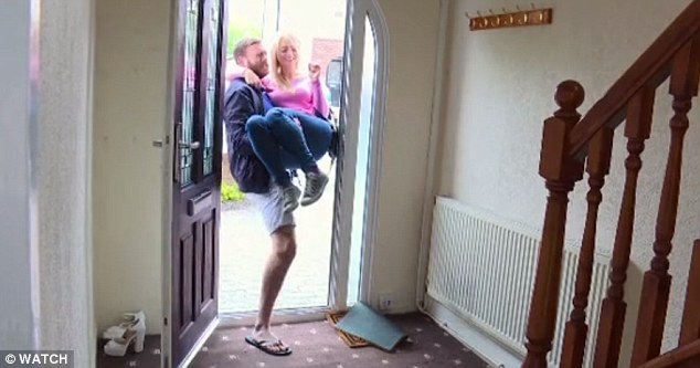 Paul carries Sophie over the threshold of their new home - which she now loves