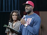 First lady Michelle Obama looks at Cleveland Cavaliers' basketball player LeBron James as he speaks at The University of Akron, Wednesday, Oct. 21, 2015, in Akron, Ohio. James teamed up with Mrs. Obama to celebrate the importance of secondary education at a private event at the University of Akron. The NBA superstar, who went from high school to the pros, and first lady are hosting thousands of children and their parents at the school. (AP Photo/Tony Dejak)