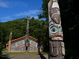 ALASKA, UNITED STATES - 2013/08/20: Tlingit totem pole with clan house in the background at the Totem Bight State Historical Park in Ketchikan, Southeast Alaska. (Photo by Wolfgang Kaehler/LightRocket via Getty Images)