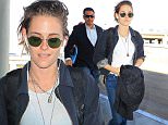 Kristen Stewart and her new pink-haired girlfriend arrive in Los Angeles.  Kristen dressed casual for the flight, in jeans and sneakers, with a t-shirt and un-buttoned button-up.  Saturday, October 24, 2015 X17online.com