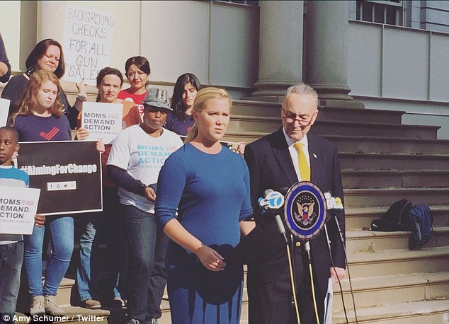 Comedian Amy Schumer and her cousin, Senator Charles Schumer of New York, stood in front of City Hall on Sunday (pictured)  to call for stricter gun control measures in New York