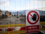 A sign hanging on a fence reading "prohibited access" is seen along ancient Roman cobbled street at the UNESCO World Heritage site of Pompeii, October 13, 2015. Years of neglect at the ancient Roman city of Pompeii are being dug and scrubbed away in a last-minute bid to keep money flowing from a huge European Union-backed renovation programme. Picture taken October 13, 2015. To match Feature ITALY-POMPEII/   REUTERS/Alessandro Bianchi