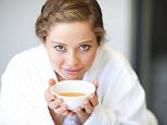 Young woman drinking tea --- Image by © Zero Creatives/Image Source/Corbis
