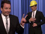 27 October 2015 - Los Angeles - USA  **** STRICTLY NOT AVAILABLE FOR USA ***  Jimmy Fallon re-enacts his latest accident and shows off his injuries on The Tonight Show. Fallon poked fun at himself injuring his other hand over the weekend after taking a spill. 'Welcome to The Tonight Show, I'm your host Trippy Fallon,' the 41-year-old chat show host said after flashing a peace sign - after walking out on stage wearing a yellow hard hat and safety glasses. He then revealed: "I had another mishap. This time I injured my other hand right after getting an award from Harvard. Even when I get into Harvard, I still embarrass my parents." He then showed off the children's plasters featuring Elmo on hnis fingers - before re-enacting how he fell over a girl who was kneeling in front of him and dropped a bottle of Jagermeister - and then fell onto the glass. He injured his other hand on Saturday after receiving a humor award from the Harvard Lampoon in Boston. Fallon needed emergency surgery four
