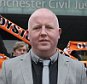 David Ragozzino (who has been charged with harassing Blackpool chairman Karl Oyston) outside the Civil Justice Centre in Manchester. Blackpool Football Club fans held a protest outside a court after club bosses began legal action to sue a supporter for £150,000 following comments he made online. Blackpool fan David Ragozzino has been served with papers by club chairman Karl Oyston, his father Owen as well as Blackpool Football Club Limited, the claims total £150,000. Lifelong Seasiders fan Mr Ragozzino, 32, a father of one made a first appearance at the Manchester Justice Centre on Thursday where dozens of fellow supporters with flags and banners held a protest march against the club and its owners. The legal action relates to comments made on a fans forum.