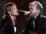 NASHVILLE, TN - NOVEMBER 04:  Musicians Keith Urban (L) and John Mellencamp perform onstage at the 49th annual CMA Awards at the Bridgestone Arena on November 4, 2015 in Nashville, Tennessee.  (Photo by Rick Diamond/Getty Images)