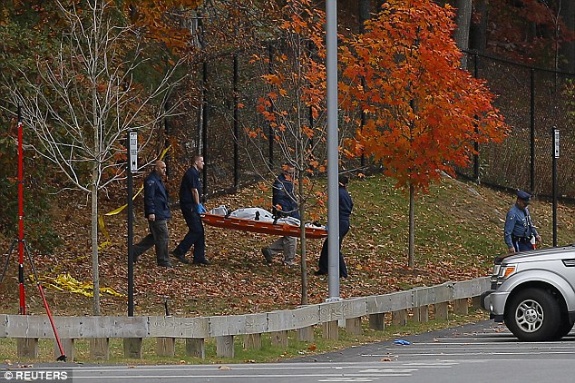 Ritzer's body being carried by police from woods where she was found hours after class finished in fall 2013