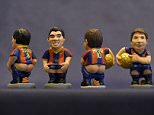 A picture taken on November 19, 2015 shows ceramic figurines of (L-R) Barcelona's Uruguayan forward Luis Suarez, Barcelona's Argentinian forward Lionel Messi and Barcelona's Brazilian forward Neymar called "Caganers" during their presentation in Torroella de Montgri, near Gerona. Statuettes of well-known people defecating are a strong Christmas tradition in Catalonia, dating back to the 18th century as Catalans hide caganers in Christmas Nativity scenes and invite friends to find them. The figures symbolize fertilization, hope and prosperity for the coming year. AFP PHOTO / LLUIS GENELLUIS GENE/AFP/Getty Images