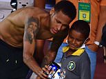 Brazilian player Neymar Junior makes a selfie with a boy after a training session in Salvador, Brazil on November 16, 2015, on the eve of a FIFA World Cup Russia 2018 qualifier match against Peru. AFP PHOTO / CHRISTOPHE SIMONCHRISTOPHE SIMON/AFP/Getty Images
