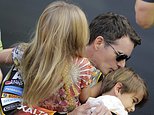 Jeff Gordon kisses his son Leo as he carries his daughter Ella while he waits backstage for the driver introductions at the NASCAR Sprint Cup Series auto race, Sunday, Nov. 22, 2015, at Homestead-Miami Speedway in Homestead, Fla. (AP Photo/Terry Renna)